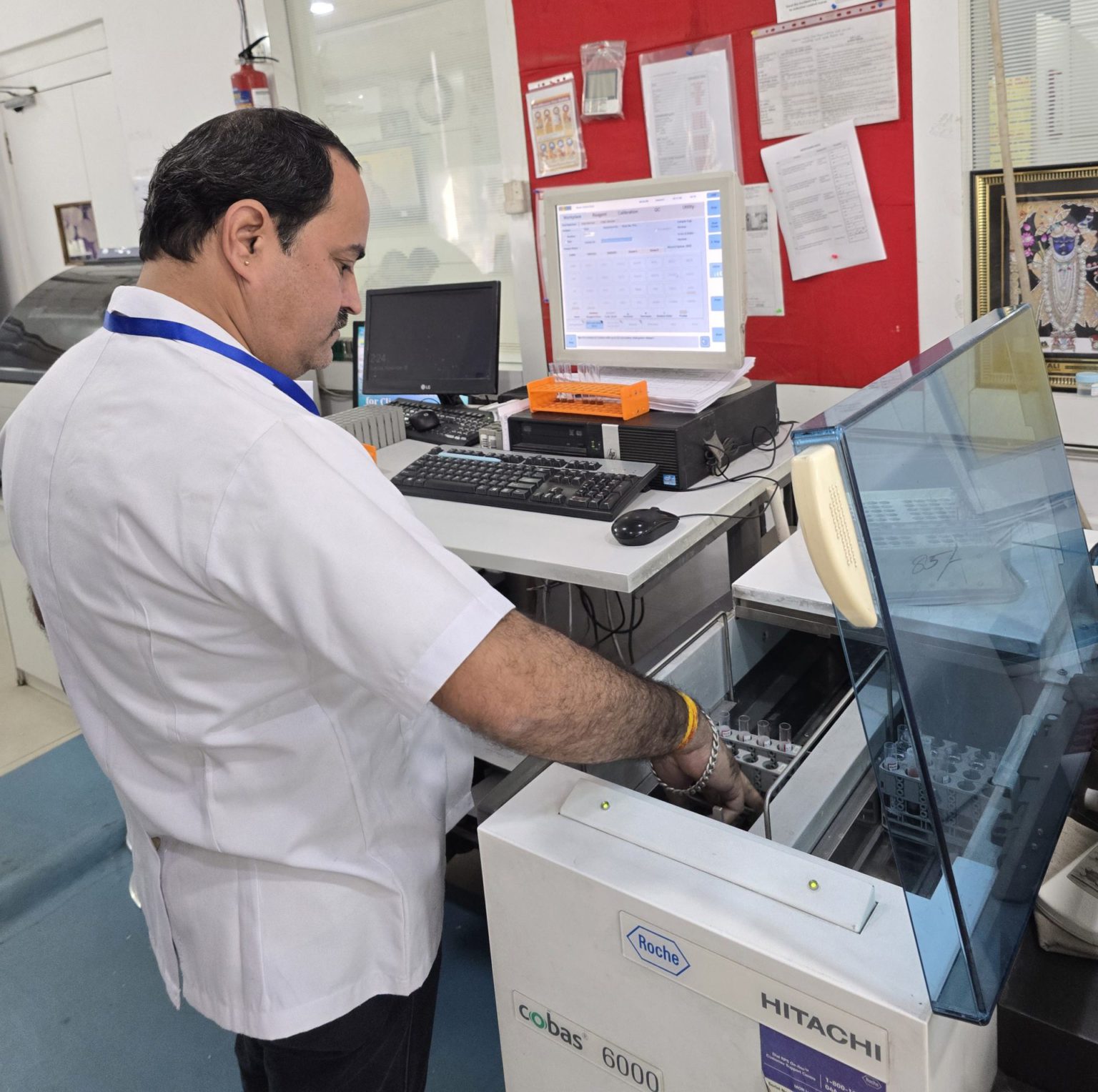 Lab technician analyzing blood samples at Arth Diagnostics to support blood collection at home in Udaipur.